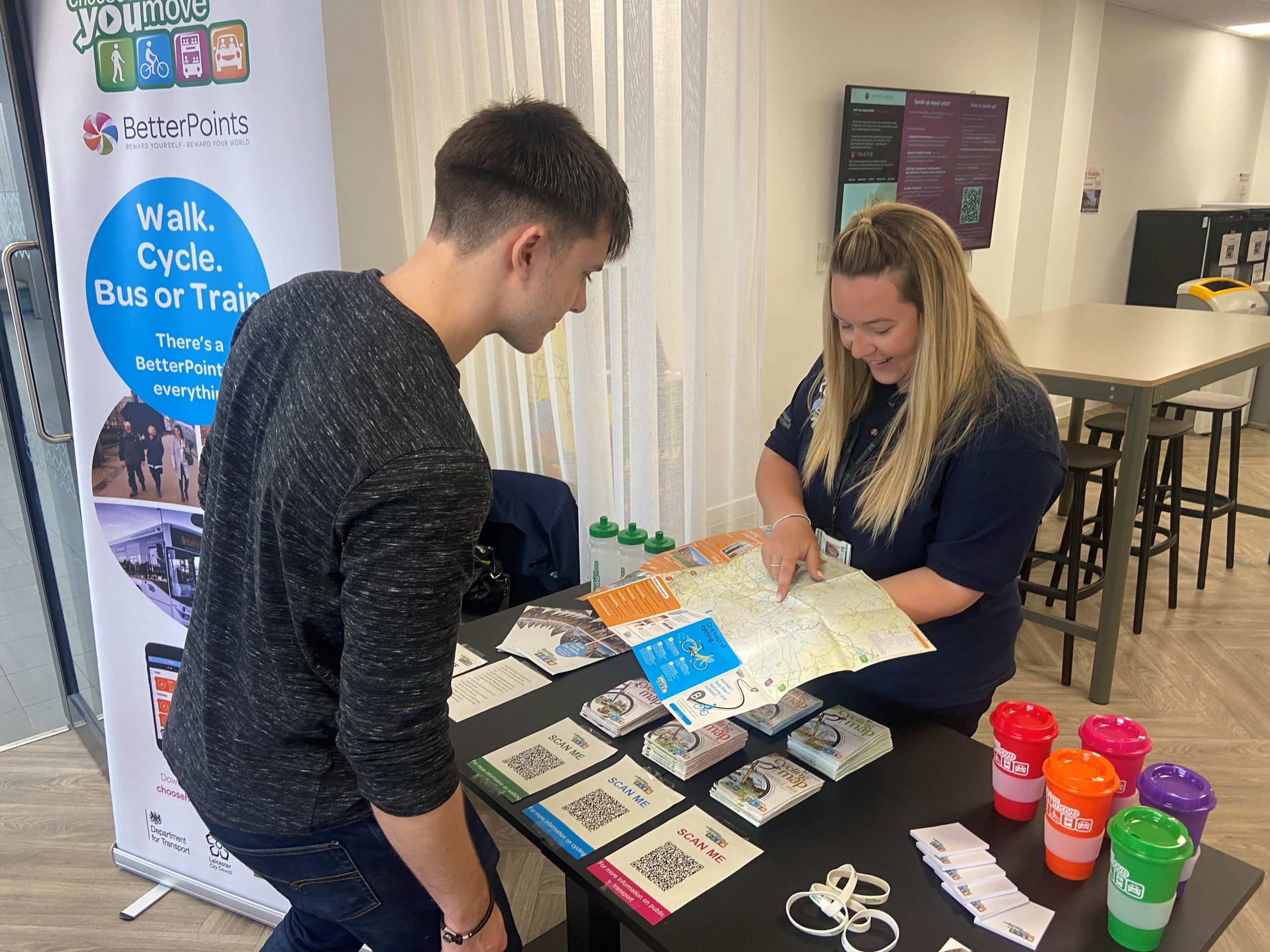 staff at an event showing a customer the cycle map for communities and events