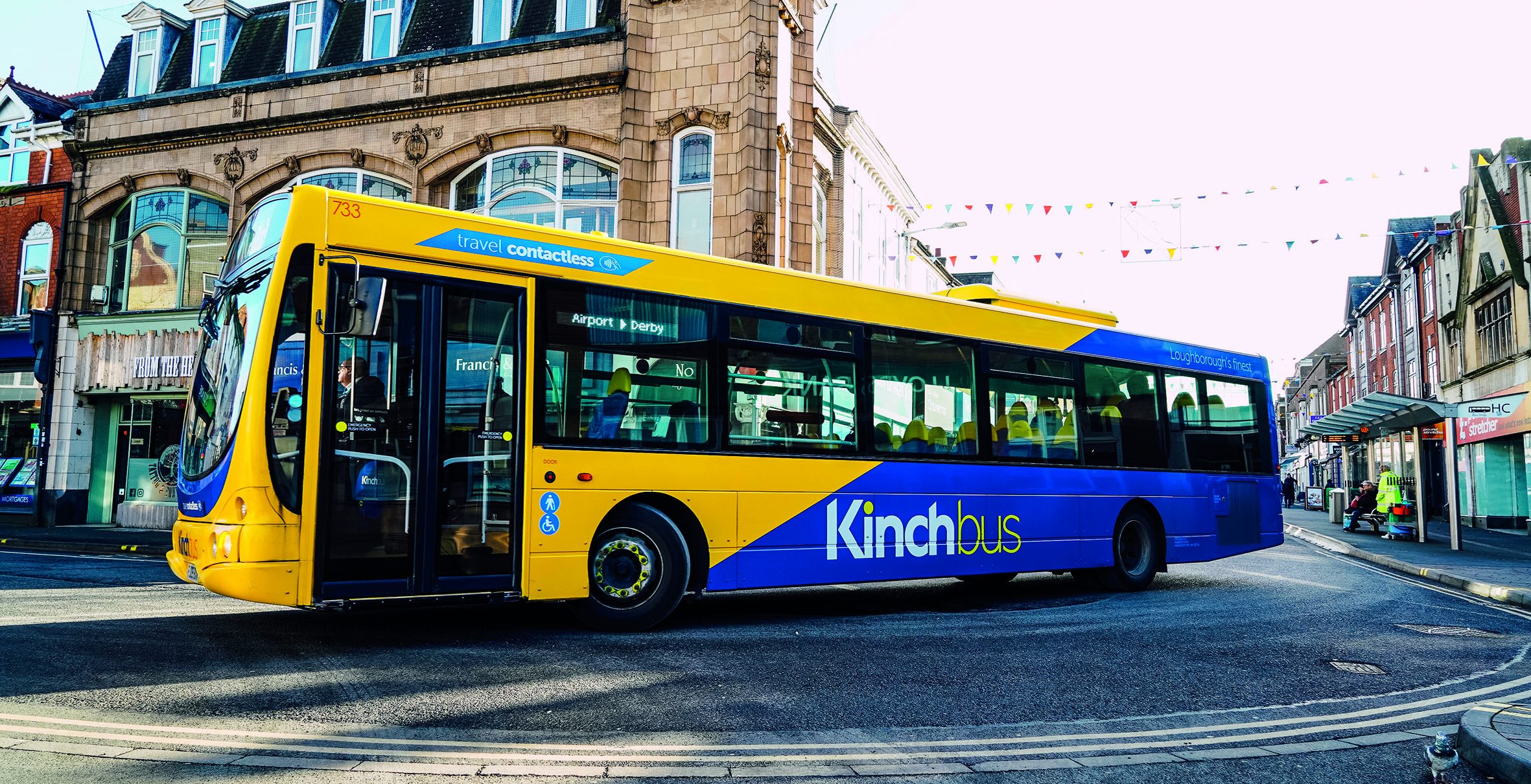 Kinchbus bus service driving on town centre road. 