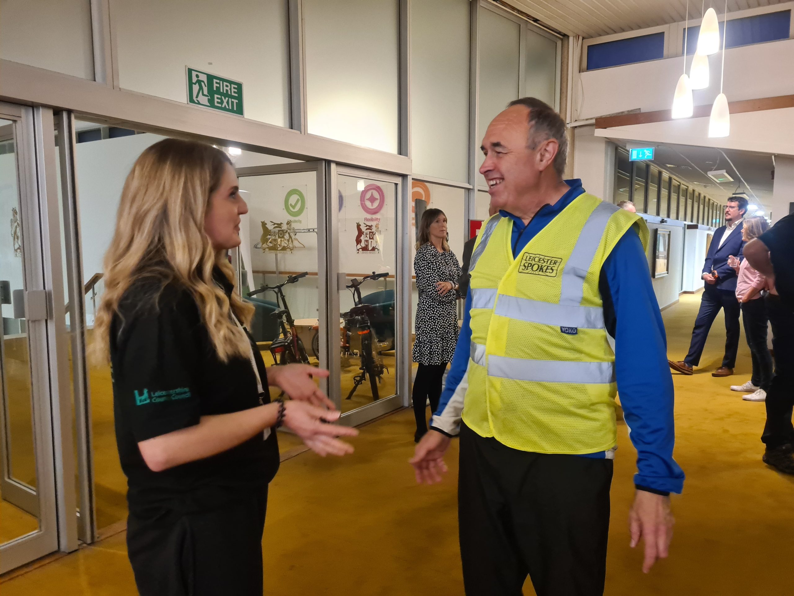 a Choose How You Move officer talking to a man in a hi-vis jacket  at the Cycling, Walking and Wheeling Forum as part of community roadshows