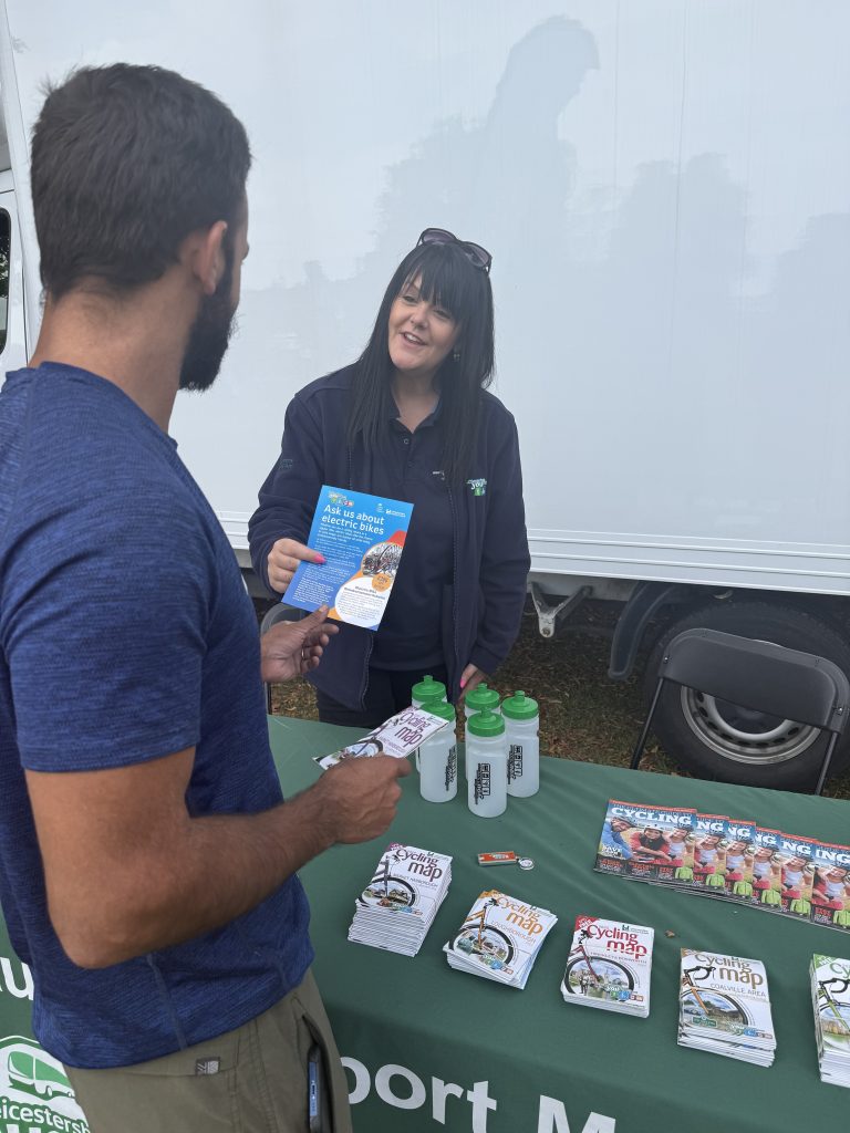 A person talking to a Choose How You Move officer at the team's community roadshows