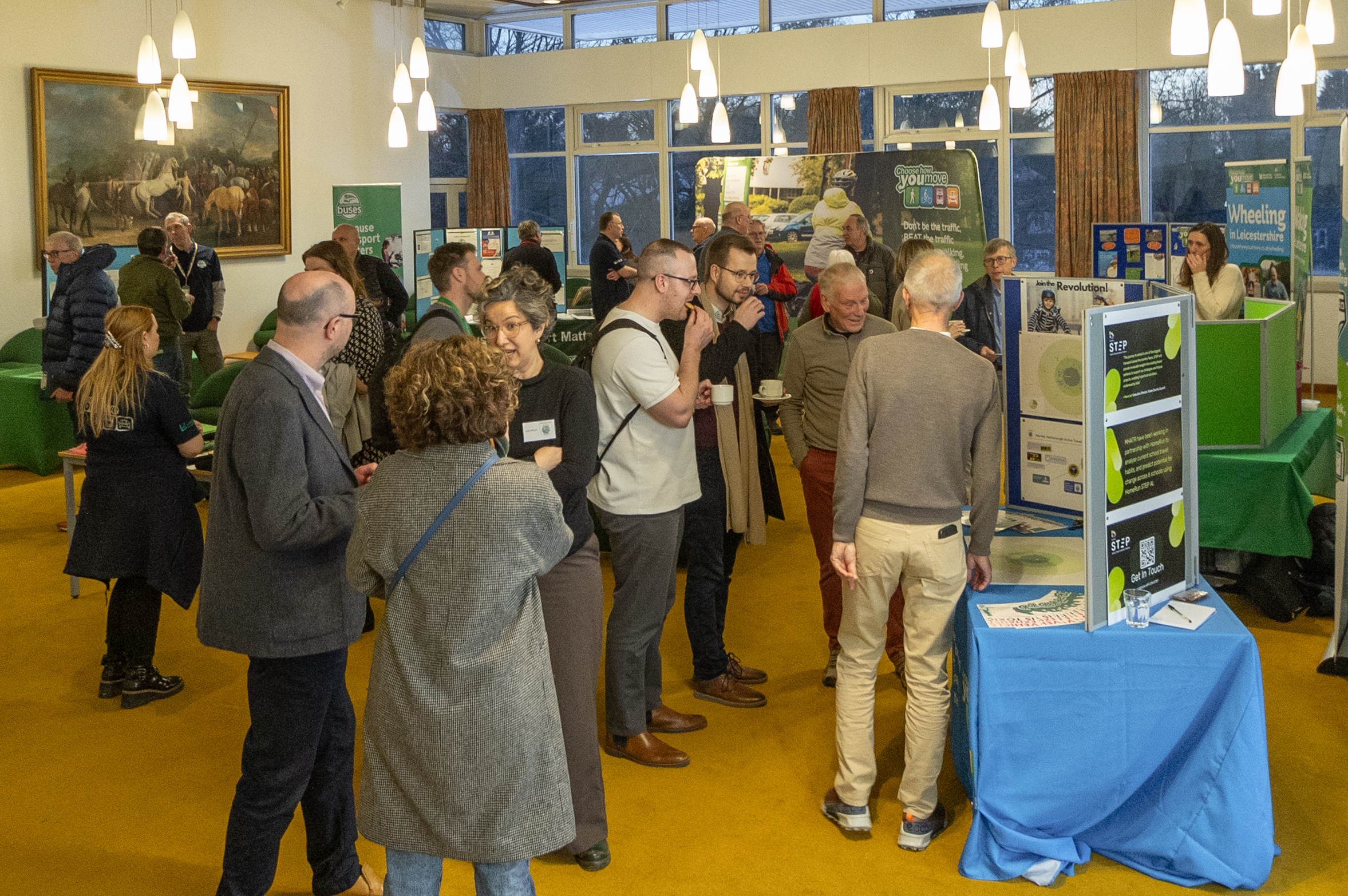 People gathering around stalls at the Cycling, Walking and Wheeling Forum
