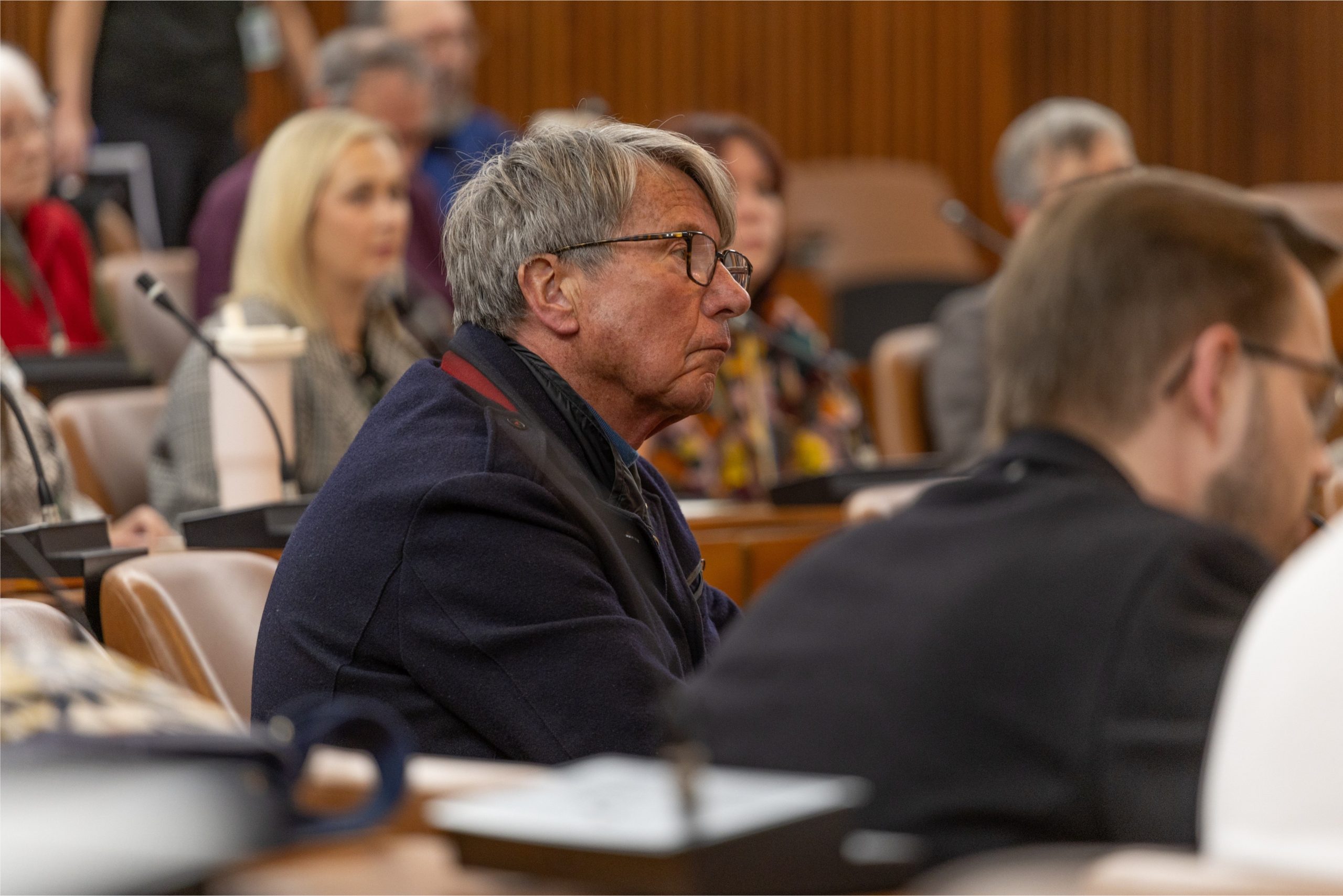 A person listening intently in a conference hall at County Hall for the Cycling, Walking and Wheeling Forum