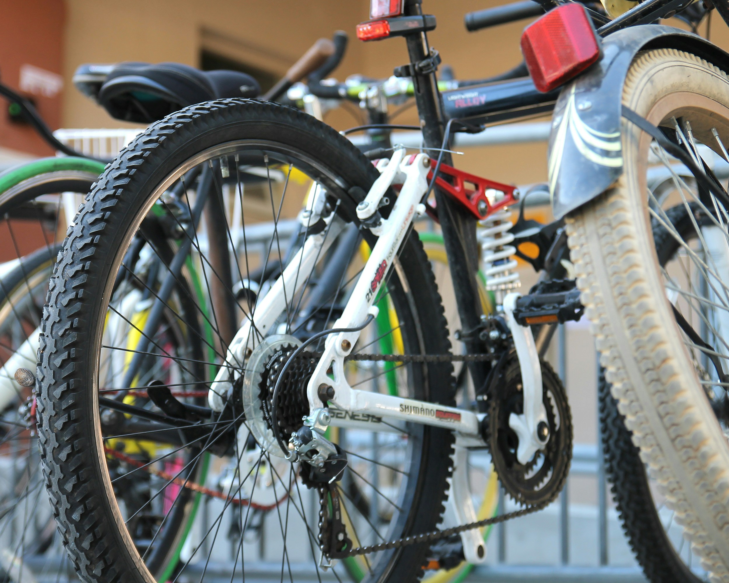 a collection of bikes against a railing as example of bikes for the Leicestershire Bike Bank