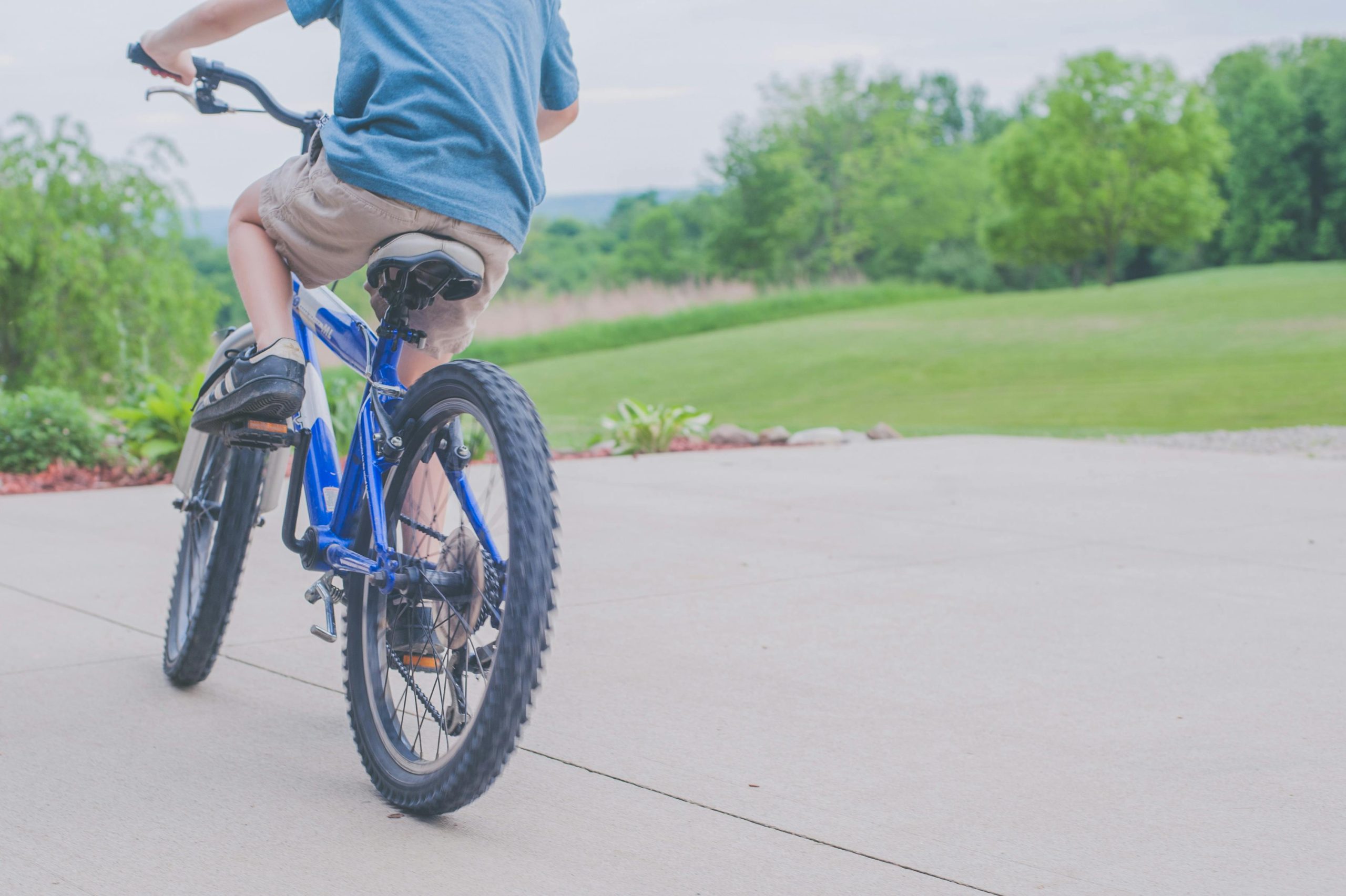 a boy riding a blue bike for the Leicestershire Bike Bank