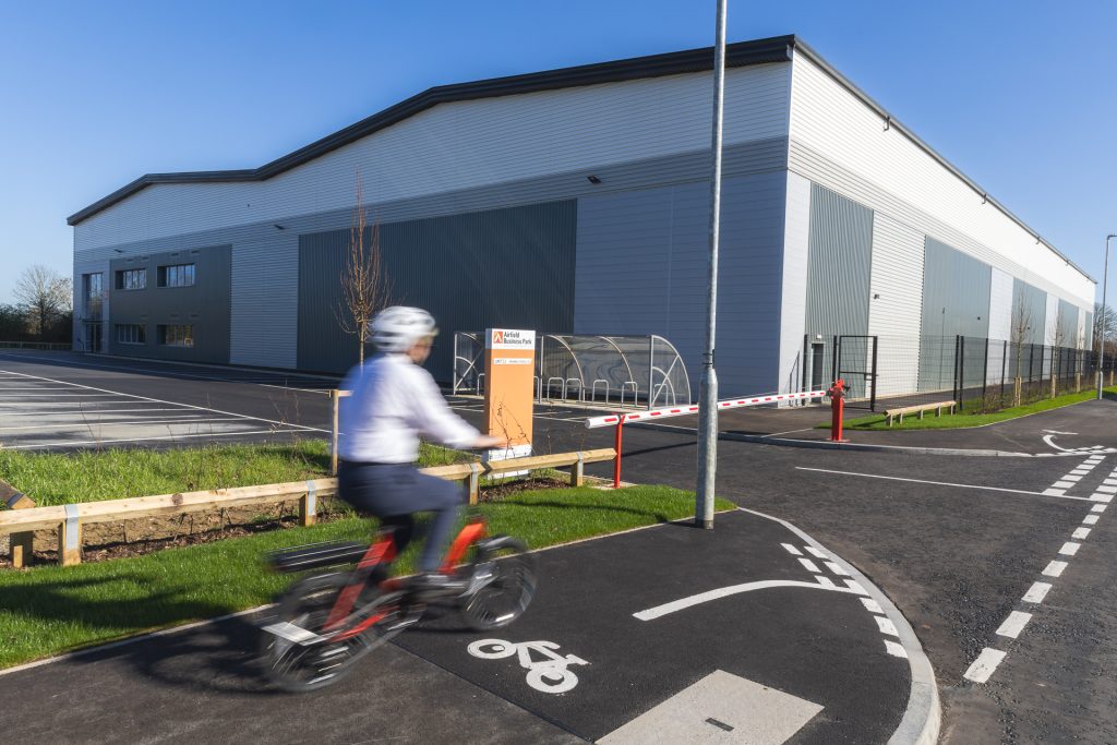 Person wearing a helmet cycling on a cycle path at Airfield Business Park - for Leicestershire Businesses - Business Programme