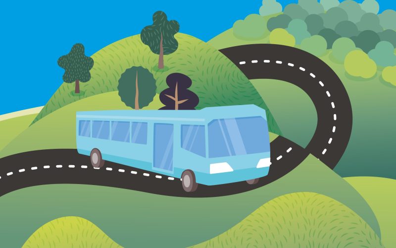 A blue bus travelling along a road as part of the Summer by Bus campaign