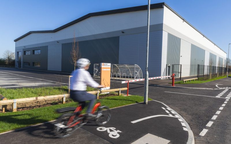 Person wearing a helmet cycling on a cycle path at Airfield Business Park - for Leicestershire Businesses - Business Programme