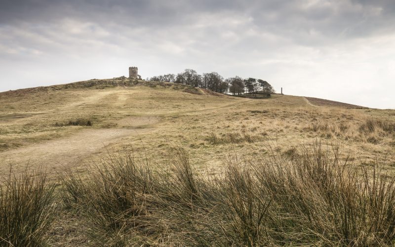 A grassy hill at Bradgate Park with a stone outhouse, Old John, at the top. For Charnwood borough.