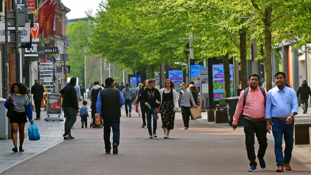 People enjoying a city centre space in Leicester.
