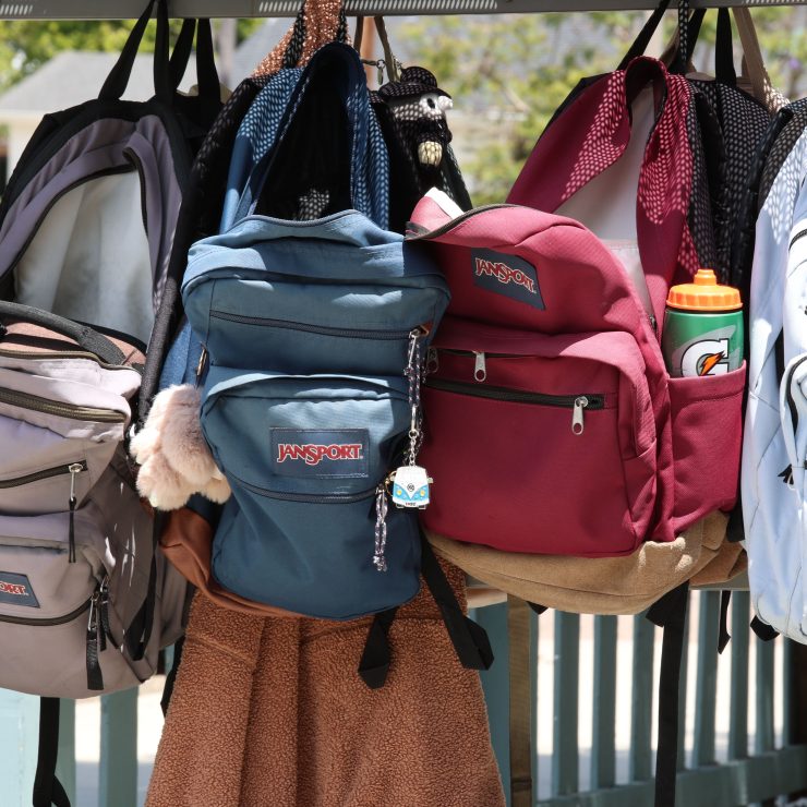 A row of school backpacks hung up in a line - for schools Active Travel Calendar