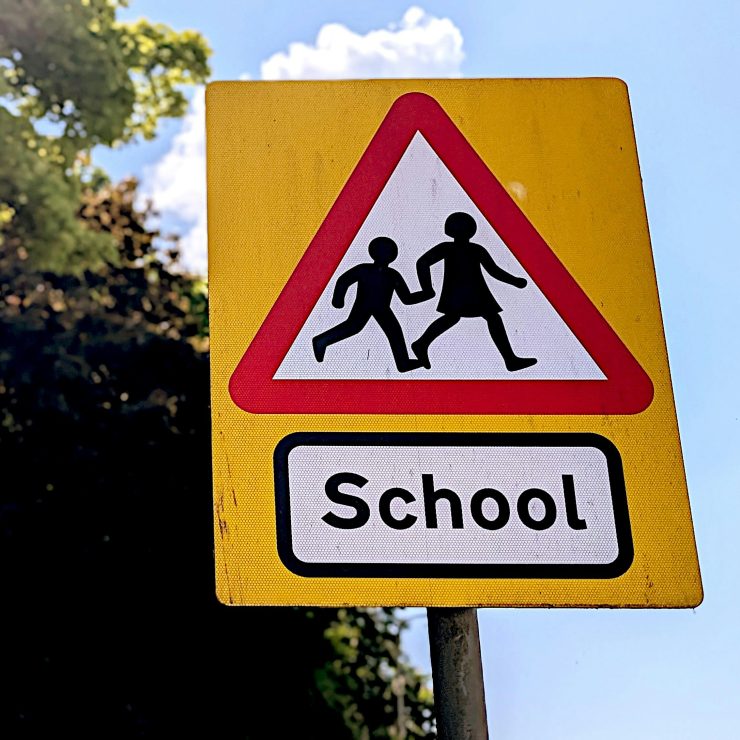 A schools warning sign for drivers on a sunny day - for schools Active Travel Calendar