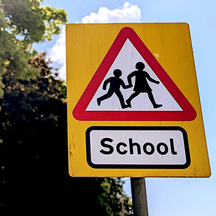 A schools warning sign for drivers on a sunny day - for schools Active Travel Calendar