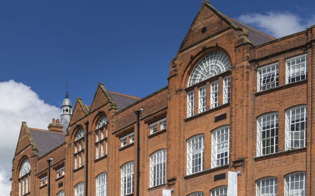 The historic Symington Building, a red brick heritage building with large arched windows and Victorian industrial architecture