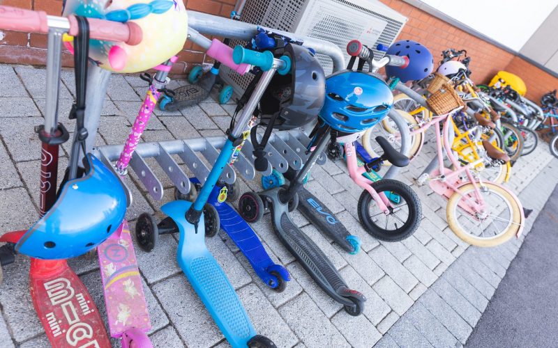 Children's scooters on a scooter rack