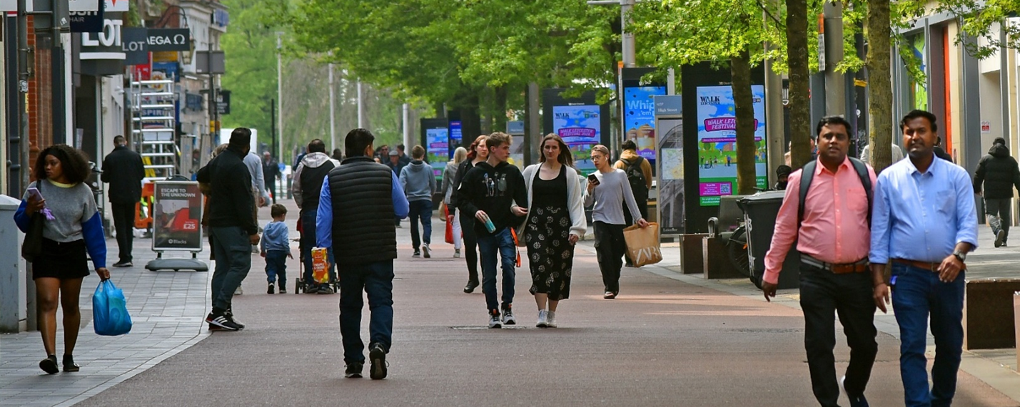 People enjoying a city centre space in Leicester.