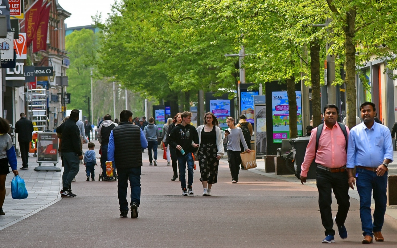 People enjoying a city centre space in Leicester.
