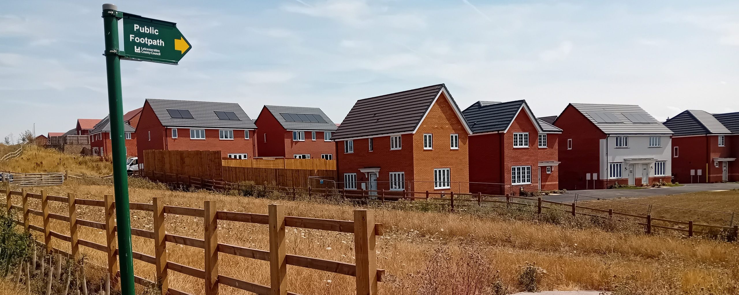 a sign for a public right of way near a new housing development in Melton Mowbray, Leicestershire, UK