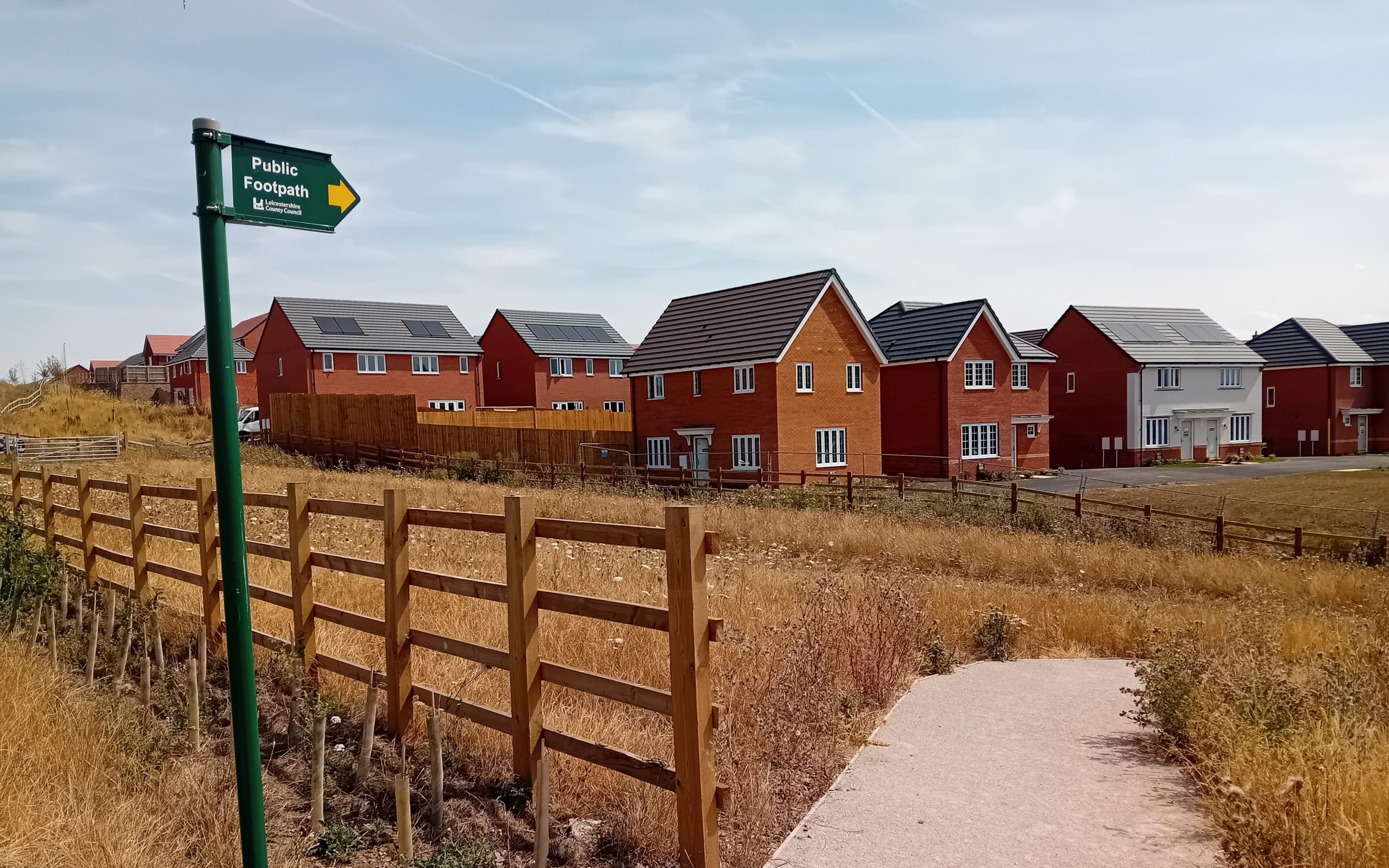 a sign for a public right of way near a new housing development in Melton Mowbray, Leicestershire, UK