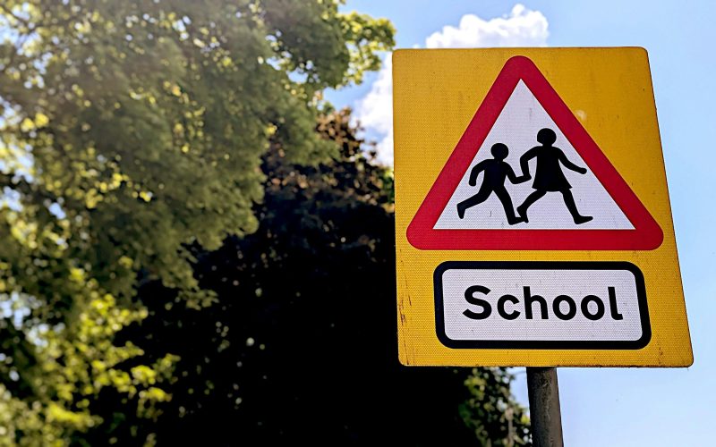 A schools warning sign for drivers on a sunny day - for schools Active Travel Calendar